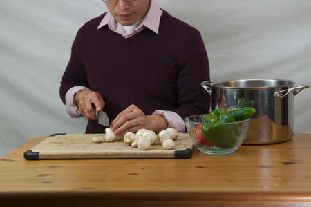 Man slicing mushroomsの写真素材
