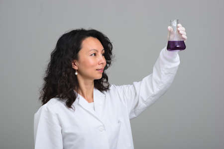Asian female scientist holding flaskの写真素材