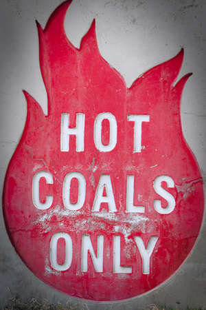 \Hot coals only\ sign on side of BBQ