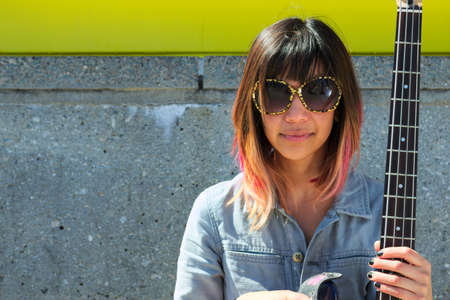 Woman with sunglasses and guitar
