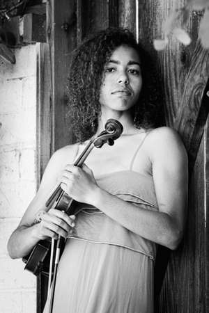 Black and white portrait of woman with violin outdoors