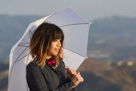 Young woman with white umbrellaの写真素材