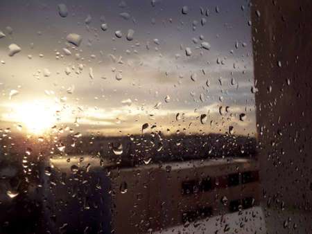 Drops of water on glass and Sun goes downの写真素材