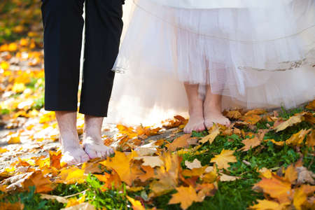 Bride and groom with bare foots on the groungの写真素材