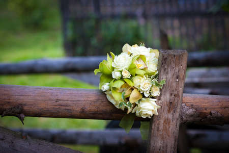 White roses wedding bouquet on rustic country fenceの写真素材