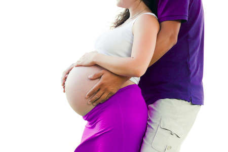 Pregnant woman holding hands around her belly の写真素材