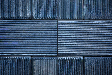 Black ceramic tiles on a wallの写真素材