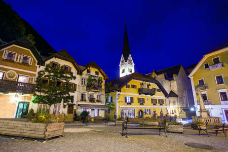 Night view of a street with Christuskirche church bell tower in Hallstatt, Austriaの写真素材