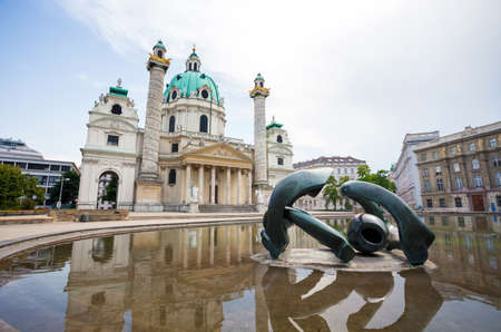 VIENNA, AUSTRIA - AUGUST 4, 2013: St. Charles's Church (Karlskirche) in Vienna with modern sculpture...