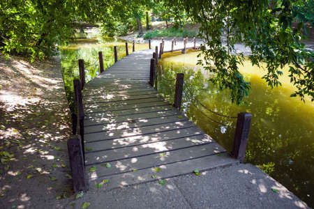 Wood bridge over the defense lake surrounding Vajdahunyad Castle, Budapest, Hungaryの写真素材