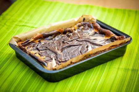 Fresh baked marble cheese cake with chocolate on cooking panの写真素材