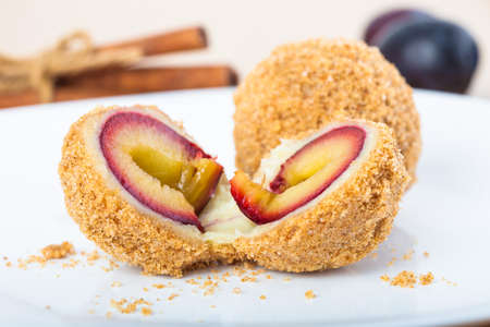 Close up of delicious sweet plum dumplings on white plateの写真素材
