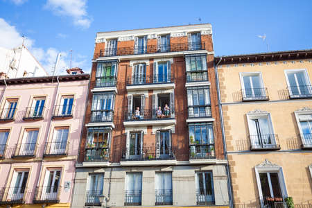 Madrid, Spain - May 6, 2012: Young girls on balconies of a typical building facade on a street of Madrid, Spainのeditorial素材