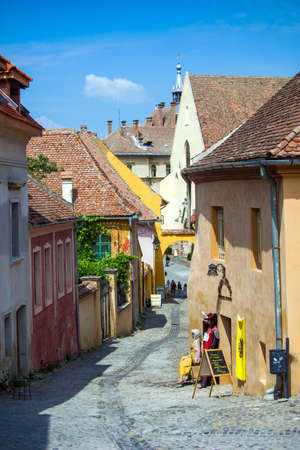Sighisoara, Romania - June 23, 2013: Old stone paved street with tourists from Sighisoara fortress, Transylvania, Romaniaのeditorial素材