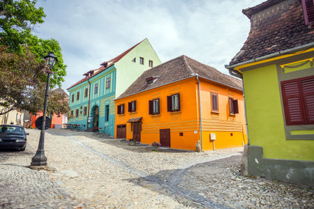 Sighisoara Romania  June 23 2013: Stone paved old streets with colored houses from Sighisoara fortresss Transylvania Romaniaのeditorial素材