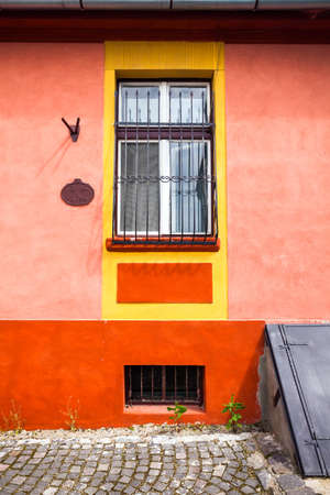 Sighisoara Romania  June 23 2013: Orange house facade with wooden window from Sighisoara city old center Transylvania Romaniaのeditorial素材