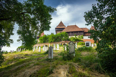 Viscri Romania  June 23 2013: Fortified Church cemetery at Viscri in Transylvania Romaniaのeditorial素材