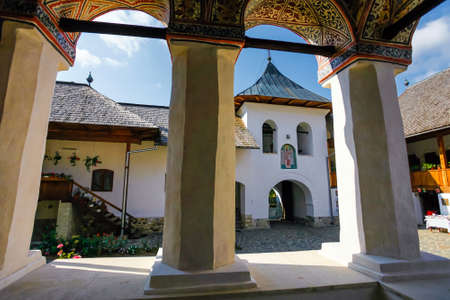 Polovragi, Romania - September 2, 2012: Inside view of the old orthodox Polovragi monastery seen trough a colonade, Romaniaのeditorial素材