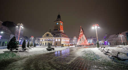 Brasov Council House night view with Christmas Tree decorated and traditional winter market in the old town center, Romaniaの写真素材