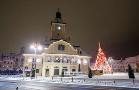 Brasov Council House night view with Christmas Tree decorated and traditional winter market in the old town center, Romaniaの写真素材