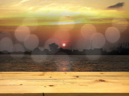 Wood for placing the product on the bokeh sunset in the sea background.