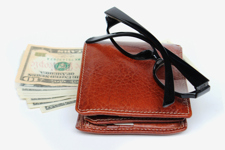 Wallets and glasses on a white background.の写真素材