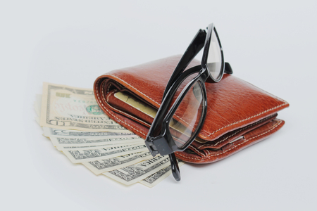 Wallets and glasses on a white background.の写真素材