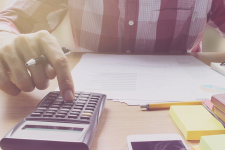 Hand use calculator on the office desk  investment and property for concept.のeditorial素材