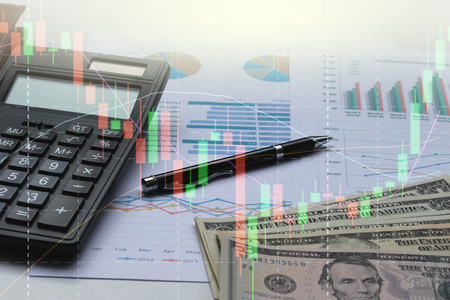 Double exposure of business calculator, dollar,financial graph and pen on office desk, stock chart in background.の写真素材