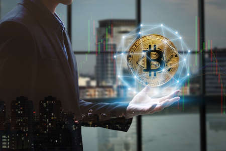 Double exposure of businessman Hand holding with golden bitcoin digital currency and network...
