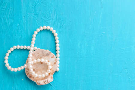 Corals and  pearls  on wooden blue backgroundの写真素材