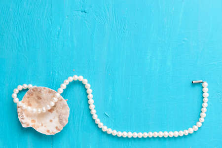 Corals and  pearls  on wooden blue backgroundの写真素材