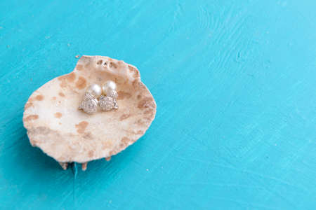 Corals and  pearls  on wooden blue background