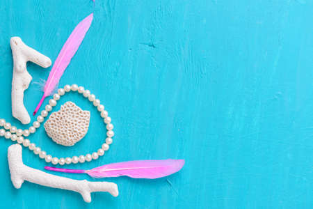 Corals and  pearls  on wooden blue backgroundの写真素材