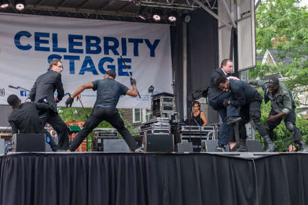 TORONTO, ON â August 11: Actors show self-defense techniques on stage on the Danforth Avenue in the Greektown district of Toronto during the Torontoâs 24th annual Taste of the Danforth street festival on August 11-13, 2017.のeditorial素材
