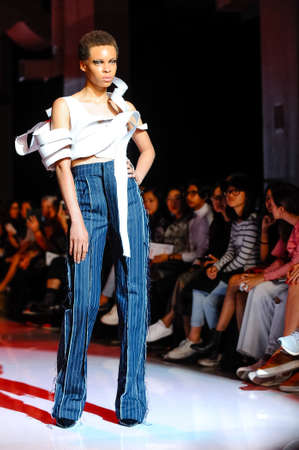 October 3, 2017. Toronto, Canada â  fashion models represents different designers clothes from Ceneca - Red collection for men and women during runway presentation at Toronto Womenâs Fashion Week on October 3, 2017 in Toronto, Canadaのeditorial素材