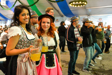 Toronto, Canada - September 29, 2017: Visitors in a festival tent of the Oktoberfest beer festival in Toronto, Ontario, Canada on September 29, 2017. The world's largest beer festival Oktoberfest take place until October 3, 2017.のeditorial素材