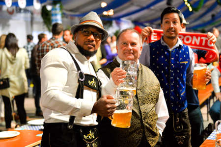 Toronto, Canada - September 29, 2017: Visitors in a festival tent of the Oktoberfest beer festival in Toronto, Ontario, Canada on September 29, 2017. The world's largest beer festival Oktoberfest take place until October 3, 2017.のeditorial素材