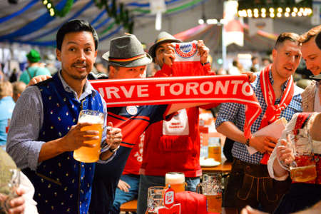 Toronto, Canada - September 29, 2017: Visitors in a festival tent of the Oktoberfest beer festival in Toronto, Ontario, Canada on September 29, 2017. The world's largest beer festival Oktoberfest take place until October 3, 2017.のeditorial素材