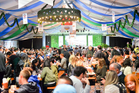 Toronto, Canada - September 29, 2017: Visitors in a festival tent of the Oktoberfest beer festival in Toronto, Ontario, Canada on September 29, 2017. The world's largest beer festival Oktoberfest take place until October 3, 2017.のeditorial素材