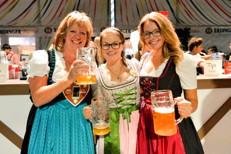 Toronto, Canada - September 29, 2017: Visitors in a festival tent of the Oktoberfest beer festival in Toronto, Ontario, Canada on September 29, 2017. The world's largest beer festival Oktoberfest take place until October 3, 2017.のeditorial素材