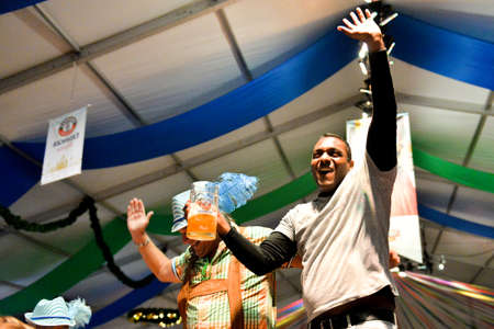 Toronto, Canada - September 29, 2017: Visitors in a festival tent of the Oktoberfest beer festival in Toronto, Ontario, Canada on September 29, 2017. The world's largest beer festival Oktoberfest take place until October 3, 2017.のeditorial素材