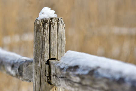 Old wooden fence in a  snow covered in winterの写真素材