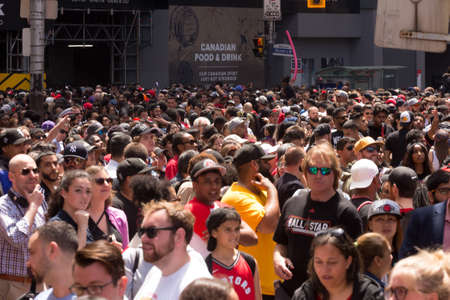 Toronto, ON, Canada - June 17, 2019 - Fans line on Downtown street as the Toronto Raptors hold their victory parade after beating the Golden State Warriors in the NBA Finals in Toronto. June 17, 2019.のeditorial素材