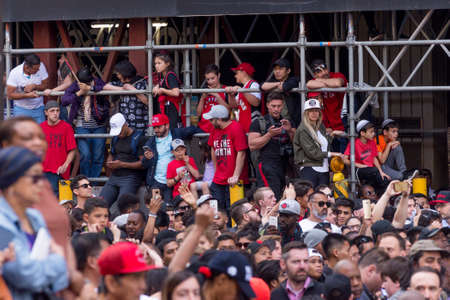 Toronto, ON, Canada - June 17, 2019 - Fans line on Downtown street as the Toronto Raptors hold their victory parade after beating the Golden State Warriors in the NBA Finals in Toronto. June 17, 2019.のeditorial素材