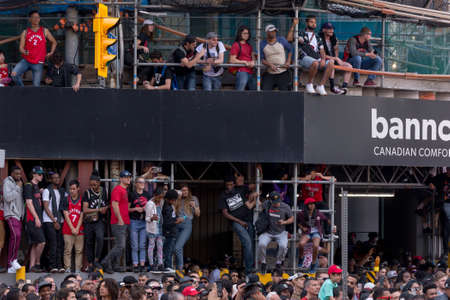 Toronto, ON, Canada - June 17, 2019 - Fans line on Downtown street as the Toronto Raptors hold their...