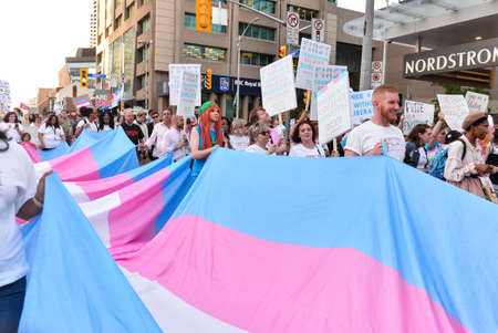 Toronto, ON, Canada - JUNE 21, 2019: Spectators display their support for transgender and non-binary people during the demonstration of the street of Toronto at Trans March and Pride Month.のeditorial素材