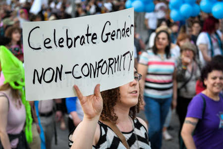 Toronto, ON, Canada - JUNE 21, 2019: Spectators display their support for transgender and non-binary people during the demonstration of the street of Toronto at Trans March and Pride Month.のeditorial素材