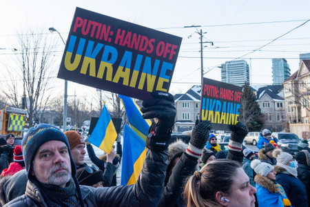 Toronto, ON, Canada â February 25, 2022:   Protestors with banners and Ukrainian flags in near Ukrainian Consulate during the demonstration against the war of Russian aggressors in Ukraine.のeditorial素材