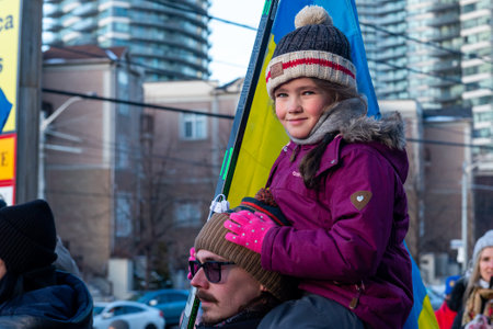 Toronto, ON, Canada â February 25, 2022:   Protestors with banners and Ukrainian flags in near Ukrainian Consulate during the demonstration against the war of Russian aggressors in Ukraine.のeditorial素材